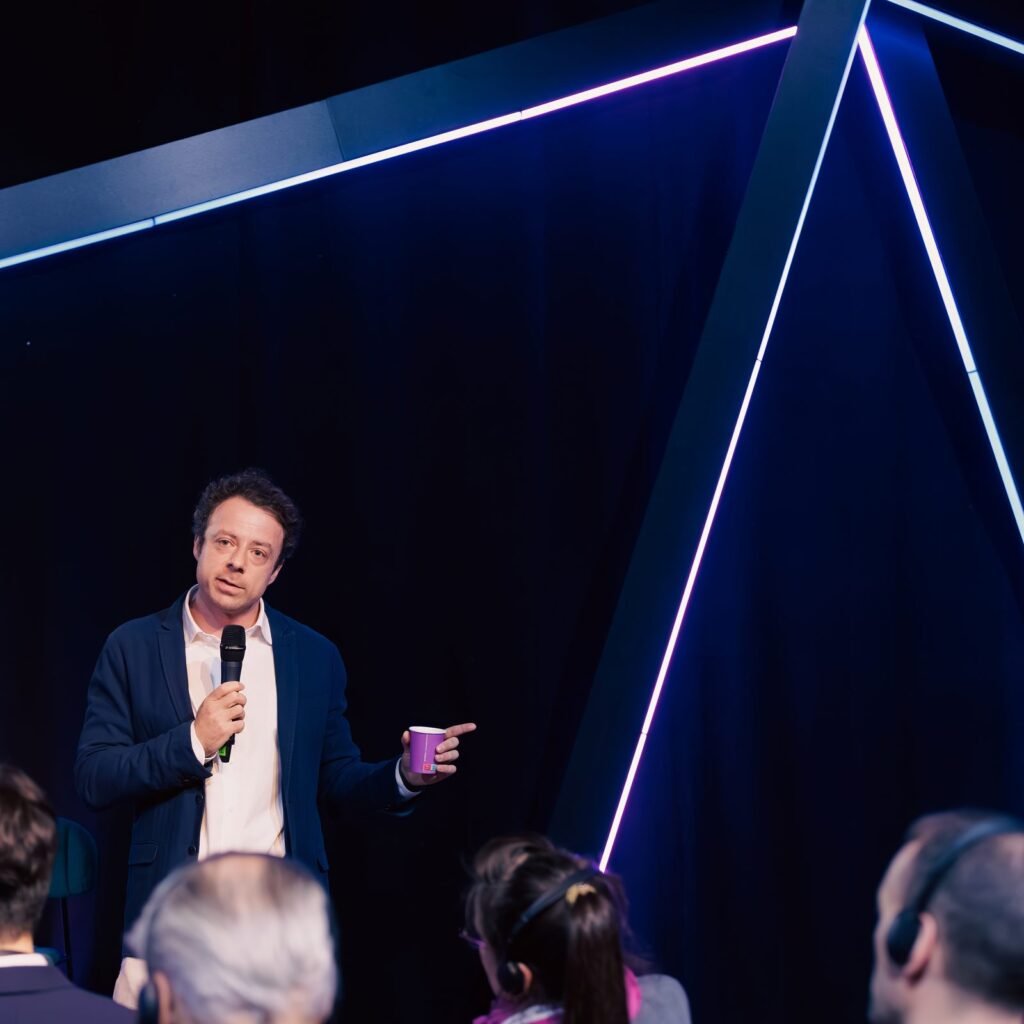 Speaker presenting on a conference stage